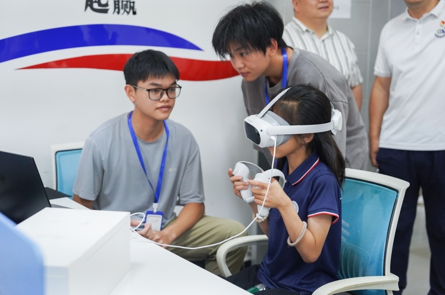 2026世界杯官网信息工程学院学生正在指导研学团成员体验VR游戏。